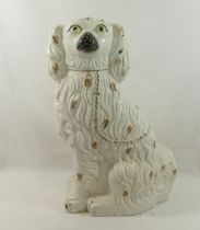 A large 19th century Staffordshire pottery spaniel, with gilt detail including chain and collar, and