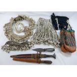 A collection of Cowrie shell decorated tribal items comprised of a headdress, shawl, belts and an