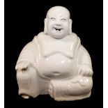 A Chinese blanc de Chine figure of Budai or Laughing Buddah, with 'Ex Collectis Erik Hancock'