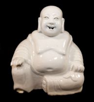 A Chinese blanc de Chine figure of Budai or Laughing Buddah, with 'Ex Collectis Erik Hancock'