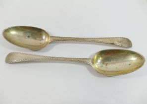 A pair of George III silver fiddle pattern table spoons, London 1778 by John Lamb, with bright cut