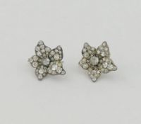 A pair of Victorian diamond flowerhead earrings, all-over set with old-cut diamonds, the central