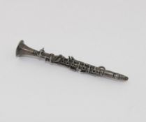 A silver clarinet brooch with import dates for London 1975, 6.8cm long, an Iona marble set ring, and
