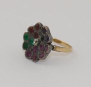 A 19th century multi-gem flowerhead dress ring, the central diamond surrounded by panels of