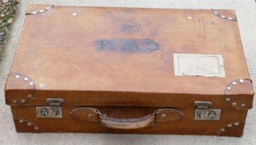 A vintage leather suitcase, with chrome plated clasps and blue fabric lined interior, with