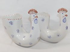 A pair of Rye Pottery chicken vases, the bodies decorated with blue flowers, with factory ink