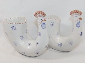 A pair of Rye Pottery chicken vases, the bodies decorated with blue flowers, with factory ink