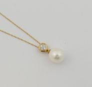 A cultured pearl and diamond pendant, the white pearl 1.1cm long, set beneath a circular diamond set