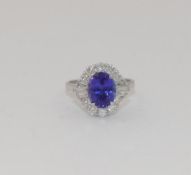 A tanzanite and diamond oval cluster ring, the oval mixed cut tanzanite, 3.00 carats, housed in four