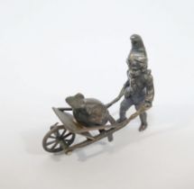 A late 19th century German Neresheimer silver figure of a gnome pushing a wheelbarrow containing a