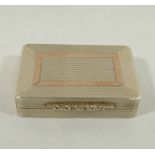 A rectangular silver pill box with gilt interior and engine turned decoration, ornate cast thumb