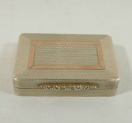 A rectangular silver pill box with gilt interior and engine turned decoration, ornate cast thumb