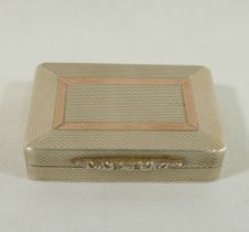 A rectangular silver pill box with gilt interior and engine turned decoration, ornate cast thumb