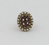 A 1970's 9 carat gold large garnet and cultured pearl cluster ring, London 1907, the head of the