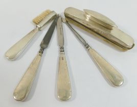 A silver handled five-piece manicure set including a nail buffer, and brush, Birmingham 1949
