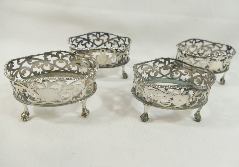 A set of four Edwardian oval pierced salts, raised on claw and ball feet, London 1901 with H E & Co.