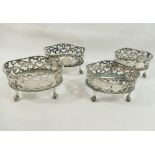 A set of four Edwardian oval pierced salts, raised on claw and ball feet, London 1901 with H E & Co.