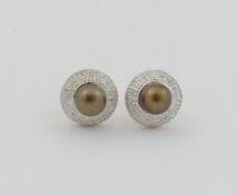 A pair of cultured pearl and diamond stud earrings, the gold/black pearls within diamond set halo