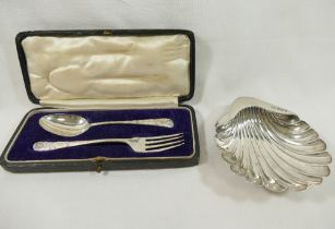 A silver shell-shaped butter dish, raised on three ball feet, Sheffield 1897, 11.9cm long, and a