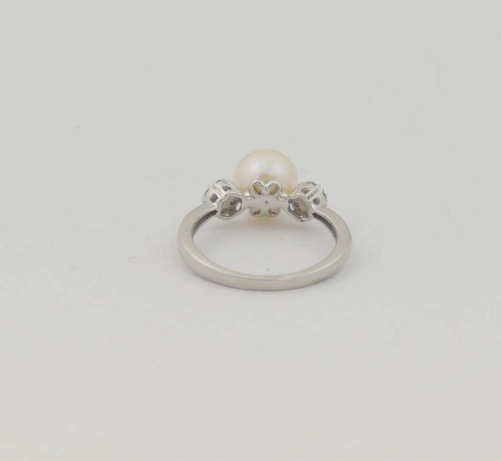 A cultured pearl and diamond ring, the central white pearl 8.15mm circumference, flanked on either - Image 3 of 3