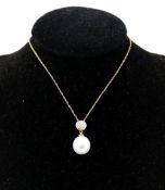 A cultured pearl and diamond pendant, the white pearl 1.1cm long, set beneath a circular diamond set