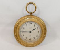 A gilt metal cased circular Jaeger wall clock in the form of a pocket watch, with battery powered