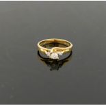 A yellow metal diamond ring, by Wah Hing of Hong Kong, the central round brilliant cut diamond