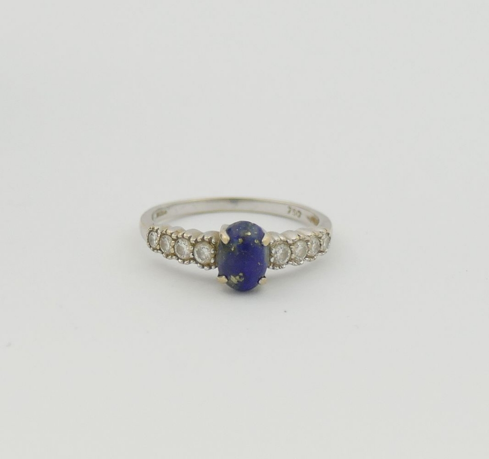An 18 carat white gold lapis lazuli and diamond ring, the oval lapis lazuli cabochon in four claw - Image 2 of 4