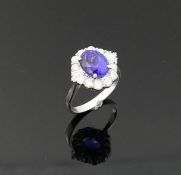 A tanzanite and diamond oval cluster ring, the oval mixed cut tanzanite, 3.00 carats, housed in four