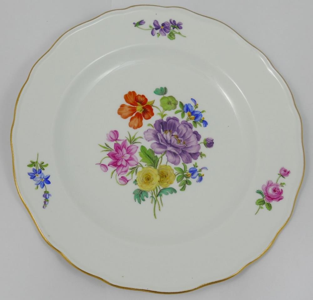 A set of four Meissen style porcelain soup plates, hand painted with floral sprays, with wavy gilt