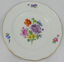 A set of four Meissen style porcelain soup plates, hand painted with floral sprays, with wavy gilt