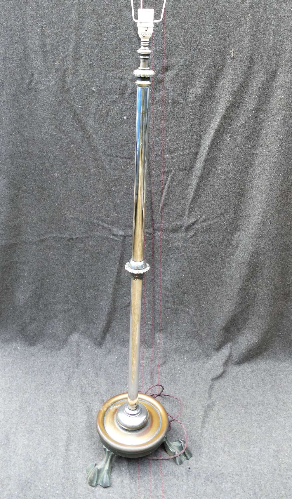 A silver plated telescopic standard lamp, on circular base raised on three claw feet, fully extended