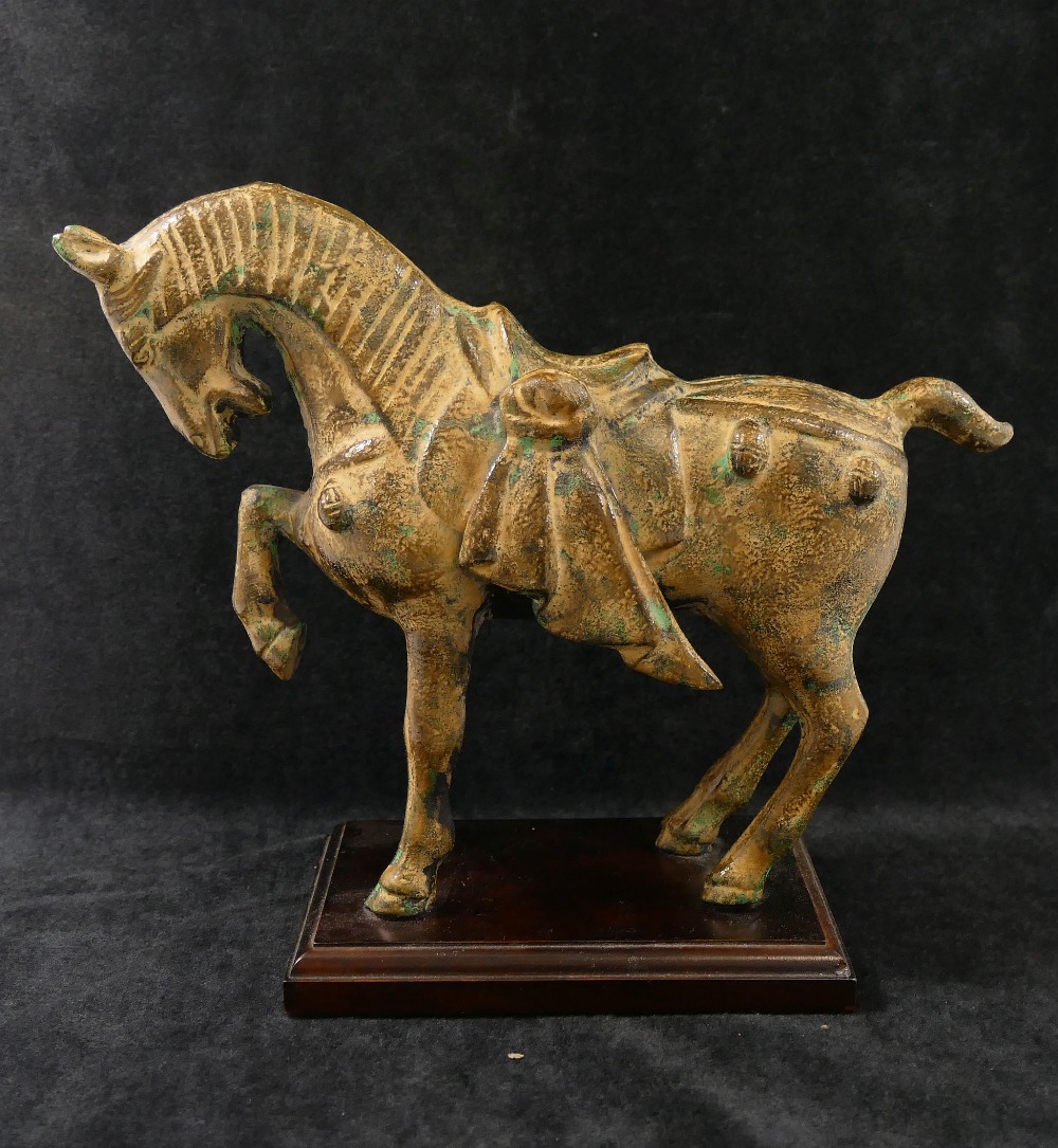 A 20th century bronze figure of a Tang horse with patinated finish, mounted to a rectangular plinth,
