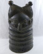 An African Mende carved helmet mask from Sierra Leone, carved with two faces (front and back),
