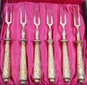 A set of six late 19th/early 20th century German .800 standard silver gilt handled small two-pronged