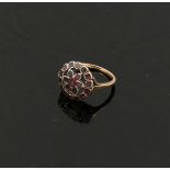 A 19th century garnet circular cluster ring, the stones in closed back silver setting, in a