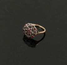 A 19th century garnet circular cluster ring, the stones in closed back silver setting, in a