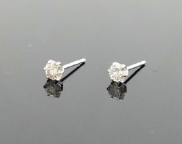 A pair of diamond stud earrings, the round brilliant cut stones, each approximately 0.10 carats,