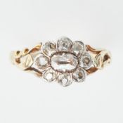 A Georgian flower design ring with ornate shoulders set with a central old cut oval shaped