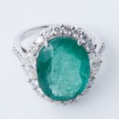An impressive 18ct white gold ring set with a central oval cut emerald, approx. 7.45 carats,
