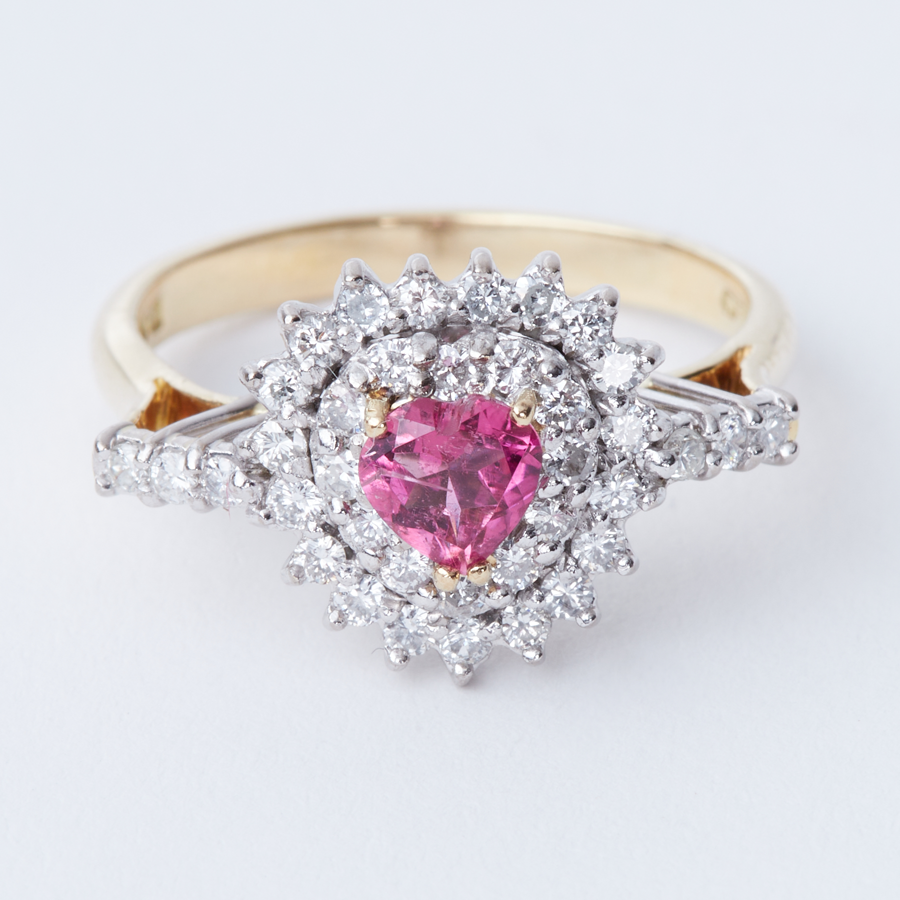 An 18ct yellow & white gold ring set with a central heart shaped pink tourmaline, approx. 0.27