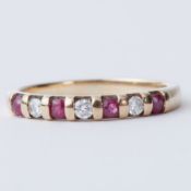 A 9ct yellow gold half eternity style ring set with round cut rubies and round brilliant cut