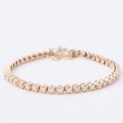 An 18ct yellow gold line bracelet set with round brilliant cut diamonds, total diamond weight