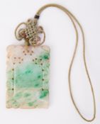 A rectangular carved jade pendant, measuring approx. 6.4cm x 4.4cm, with attached cord, total weight