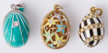 Three silver & silver gilt 'Faberge style' enamel egg pendants set with crystals, the star patterned