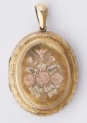 A three colour gold locket with ornate engraving to front & back, approx. 5,5cm x 3.5cm (including