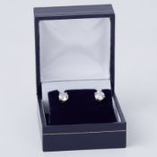 A pair of white & yellow gold stud earrings set with approx. 1.32 carats of round brilliant