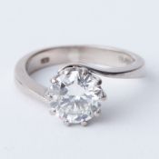 An 18ct white gold twist design ring set with a 1.50 carat round brilliant cut diamond, approx.