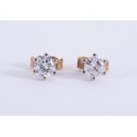 A pair of 18ct yellow & white gold studs set with round brilliant cut diamonds, total diamond weight