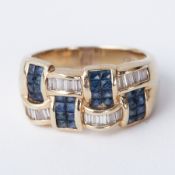 A 14ct yellow gold ring set with a mixture of princess cut sapphires and baguette cut